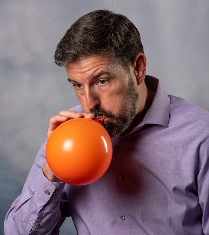 postural restoration pri breathing exercises. Pictured is Physical therapist Craig blowing up an orange balloon.